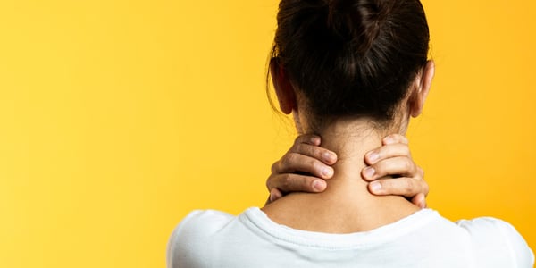 Femme de dos avec les mains placées à l'arrière de son cou